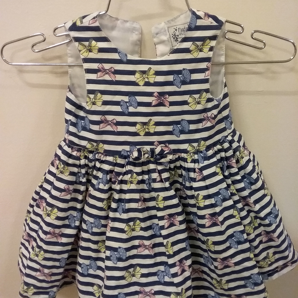 Young dimension dress showered with bows.